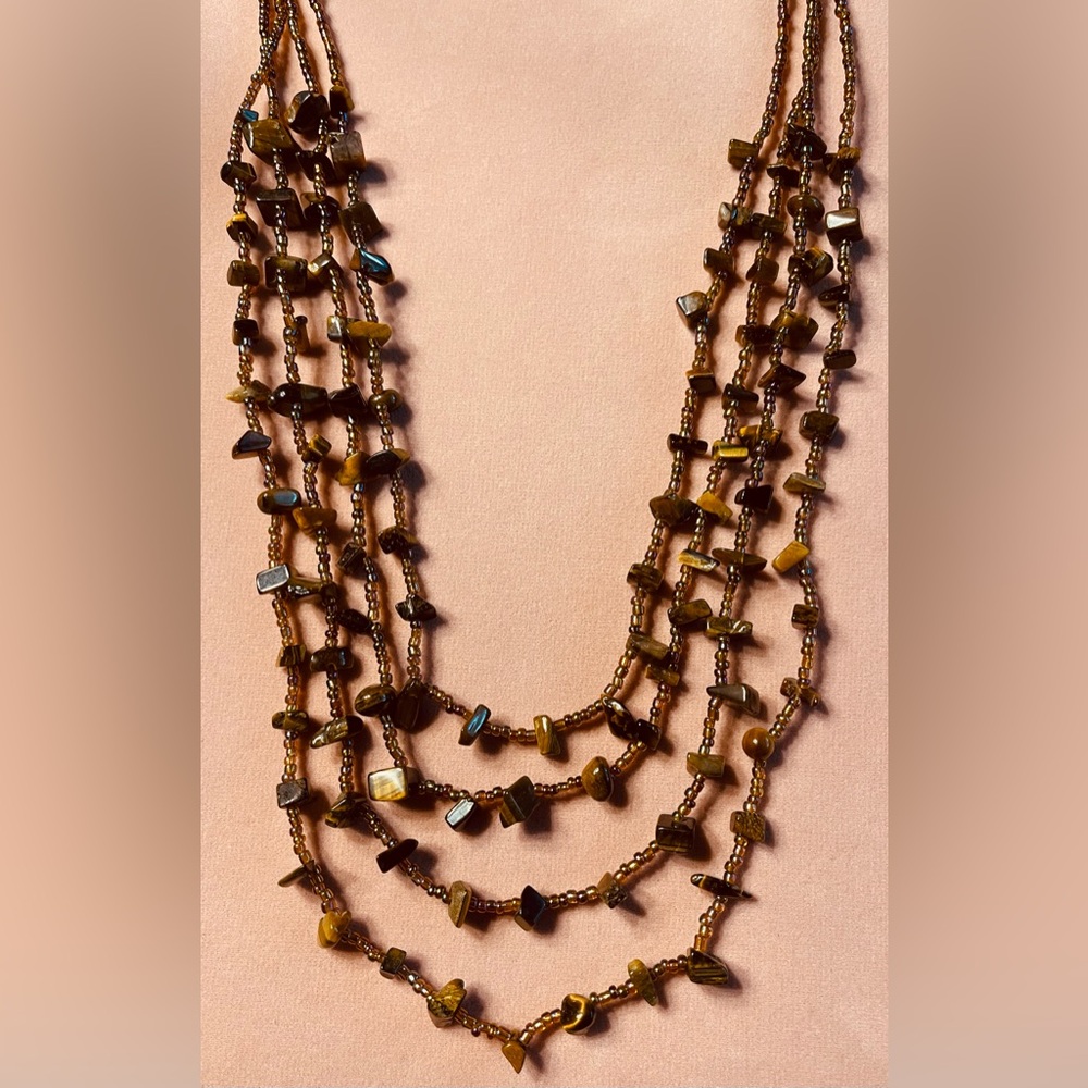 Tigers Eye and iridescent beads make up this unusual necklace. 11”w/gold clasp.